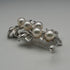 Broche vintage de plata con forma de rama y decoración de perlas