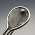 Broche antiguo de plata en forma de raqueta de tenis