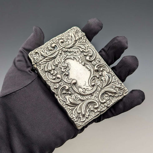 Antique American sterling silver card case with embossed decoration, 75g