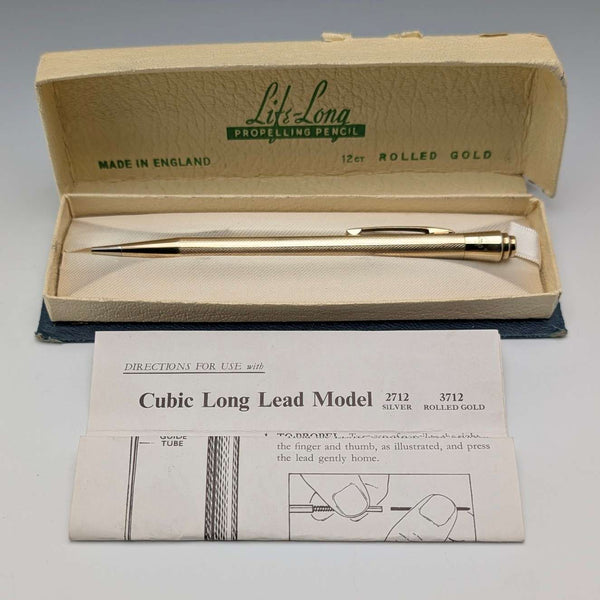 Estilográfica de propulsión vintage británica Lifelong, chapada en oro, en estuche.