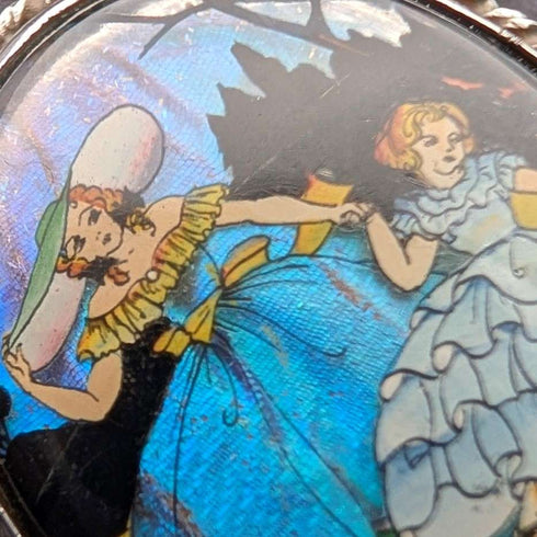 Vintage British sterling silver oval brooch featuring two women with butterfly wings