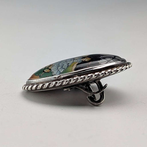 Vintage British sterling silver oval brooch featuring two women with butterfly wings