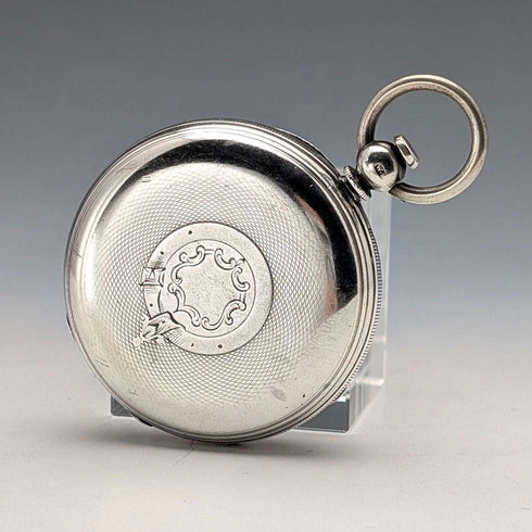 Reloj de bolsillo inglés antiguo de 1864, John Bennett, de cuerda con llave, caja de plata, esfera abierta, en buen estado de funcionamiento.