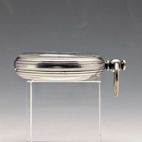 Reloj de bolsillo inglés antiguo de 1864, John Bennett, de cuerda con llave, caja de plata, esfera abierta, en buen estado de funcionamiento.