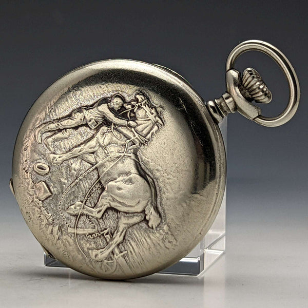 Reloj de bolsillo mecánico antiguo, en buen estado de funcionamiento, de fabricación suiza, marca E.H. Roundly, con caja tipo saboneta y grabado de caballo.